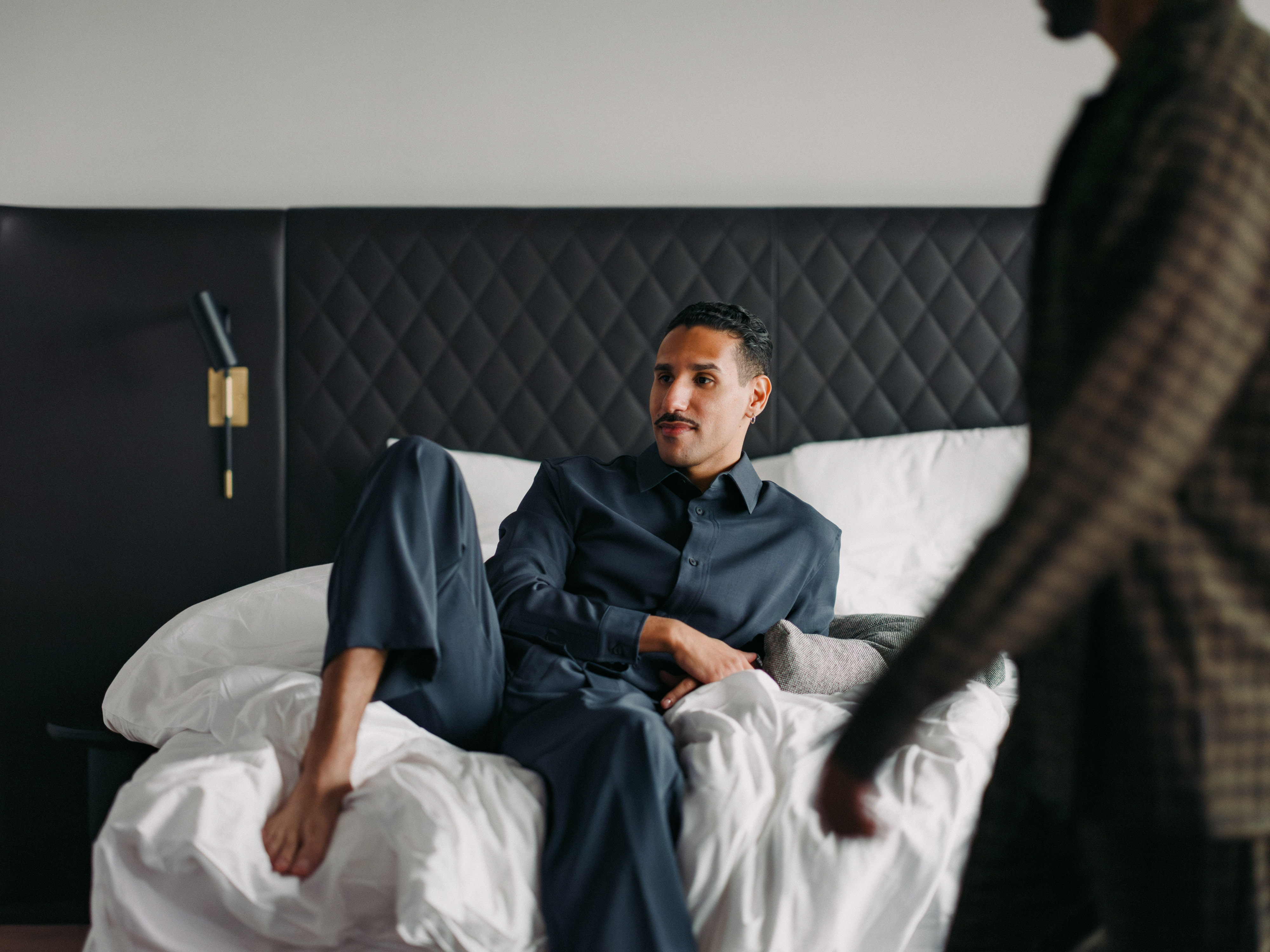 Man laying on the bed Hotel At Six