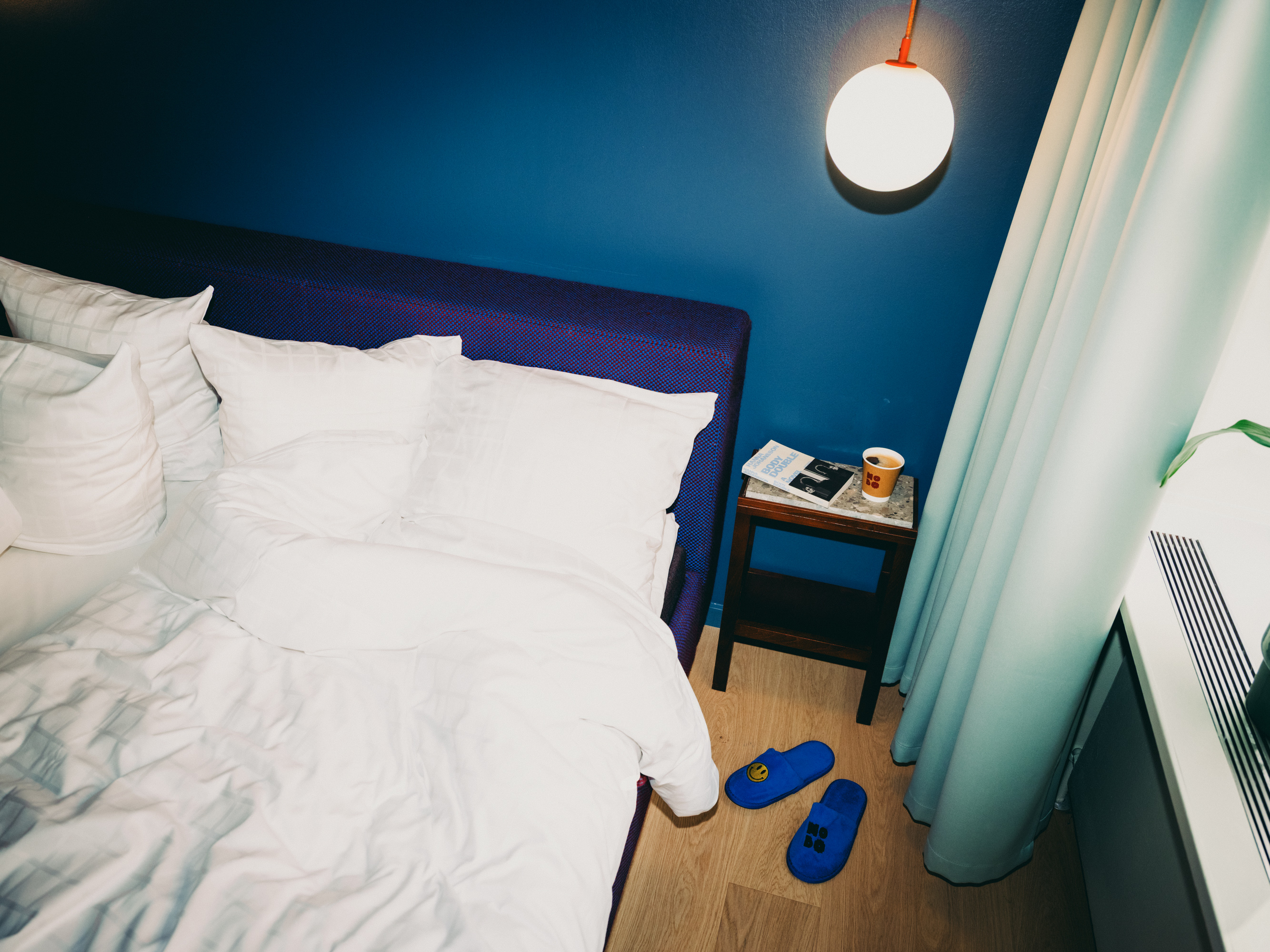 A bed with white sheets in a hotel