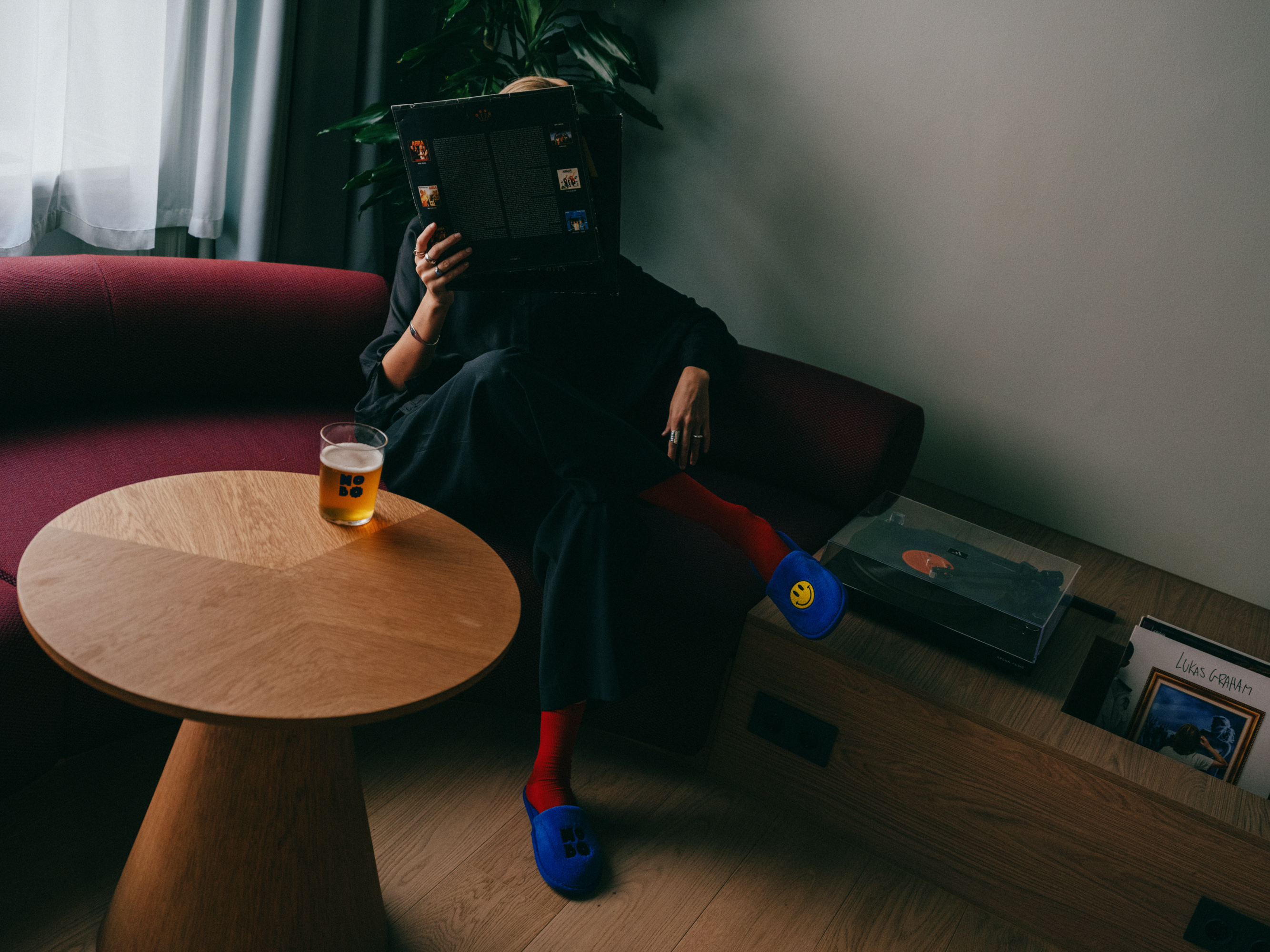 Person sits on couch reading.
