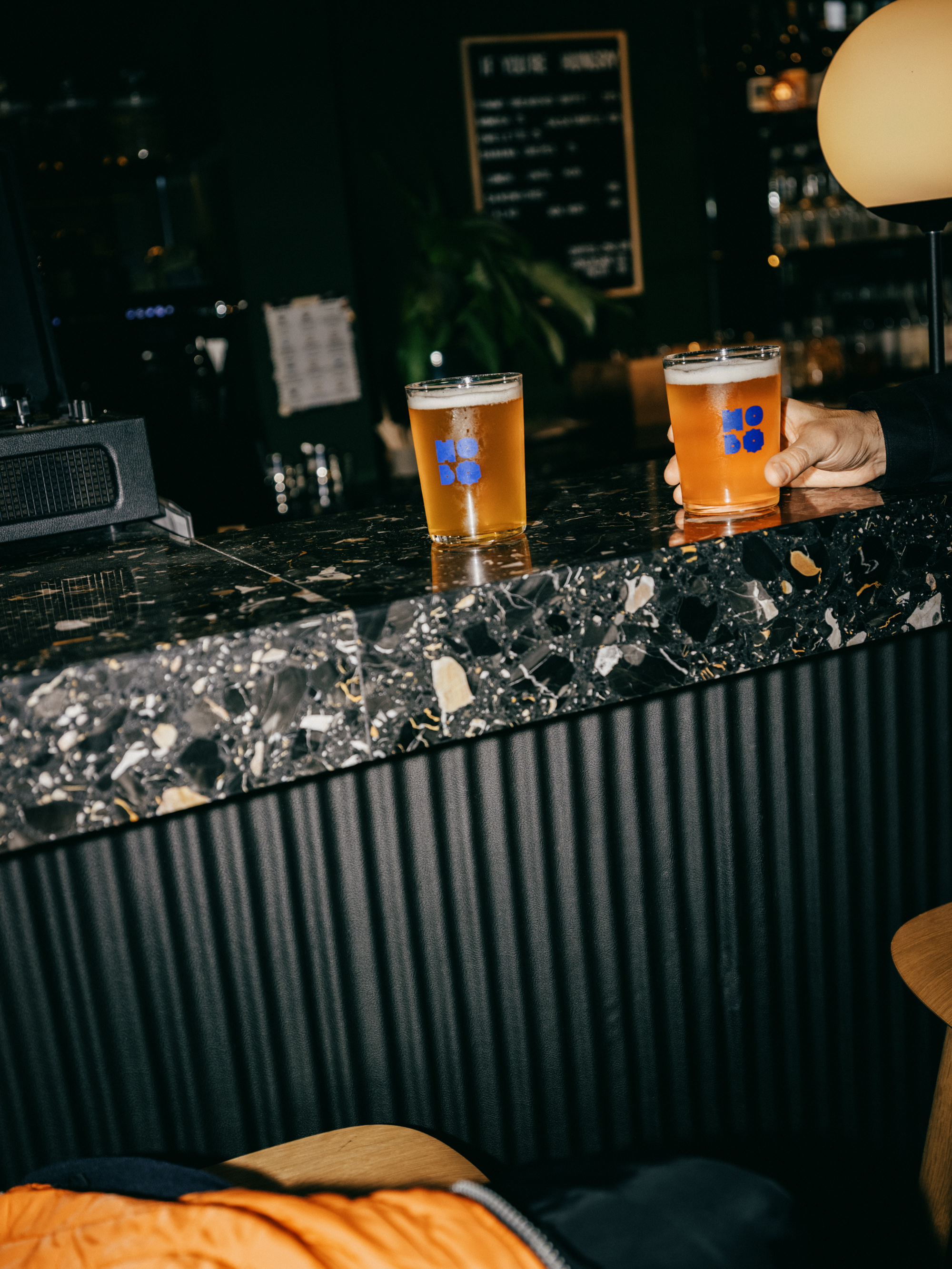 Two glasses of Hobo beer served on the terrazzo bar