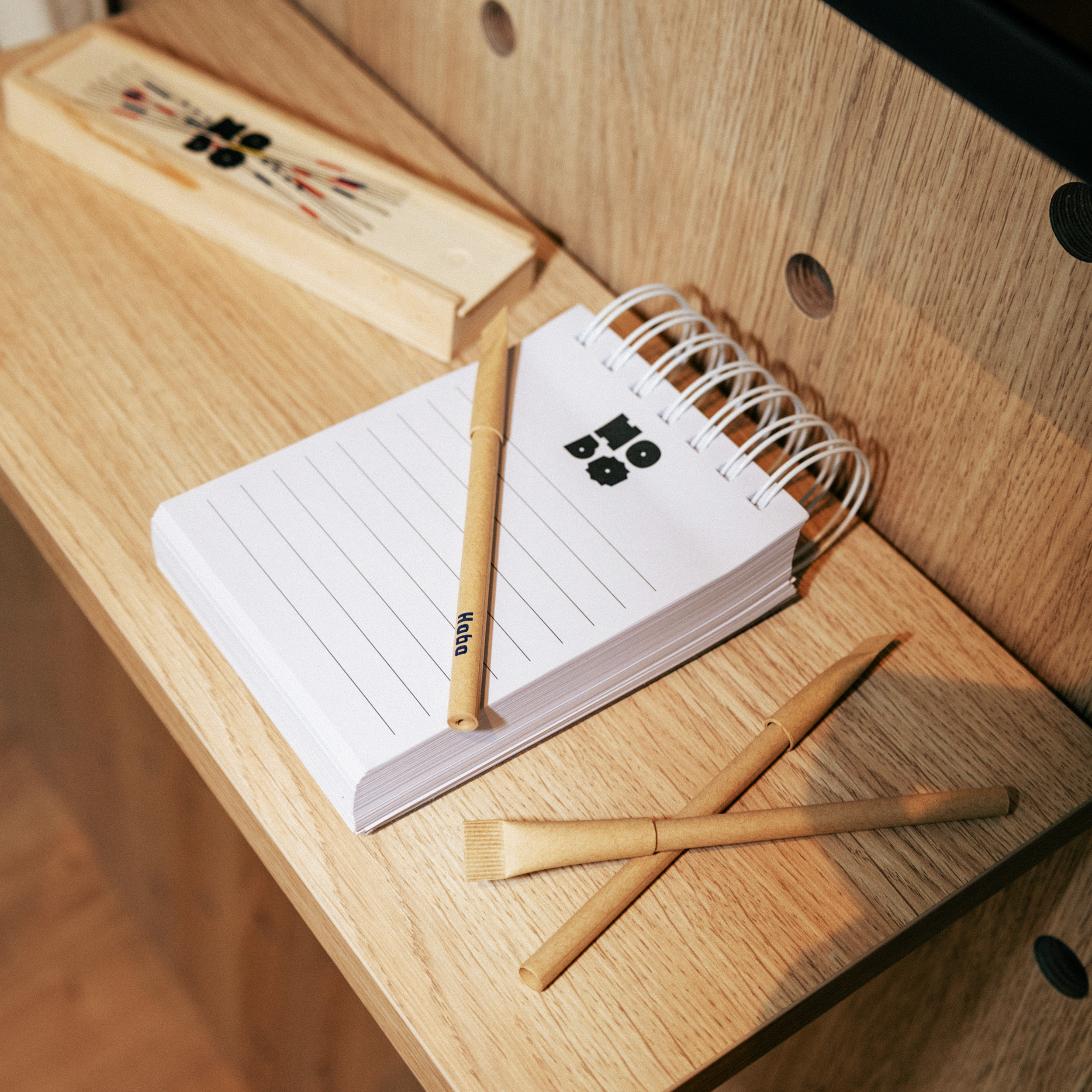 Hobo notepad and pencils on a wooden desk