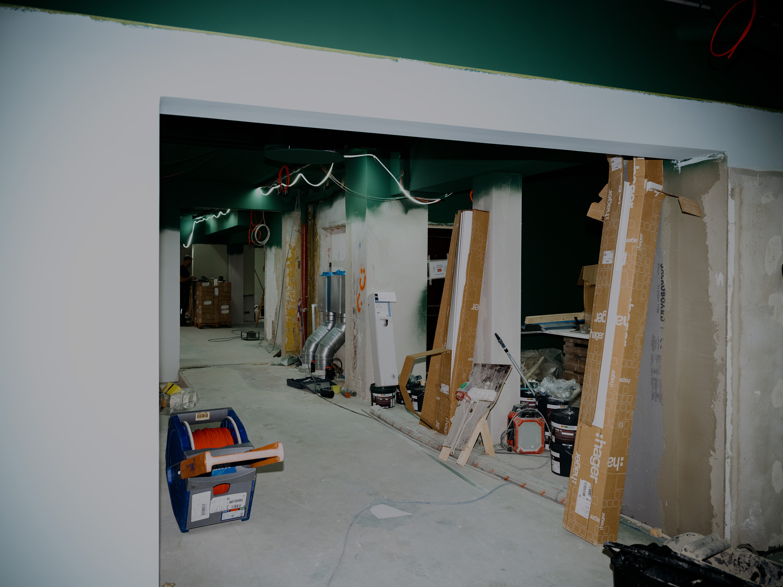Hobo Copenhagen under construction, with building materials and tools in a green-painted room